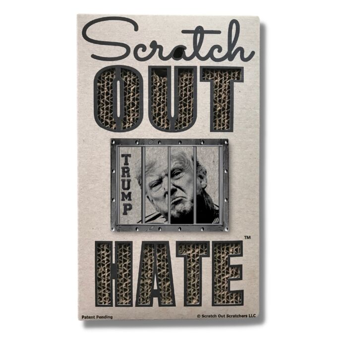 A brown cardboard cat scratcher that reads: "Scratch Out Hate" with a wood-cut design of Trump behind bars.